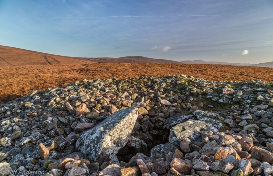 cairn-over-5000-year-old-neolithic-passage-tomb-on-top-of-621m-high-seefin-mountain-in-evening-sun-with-kippure-in-distance-rcs-7825
